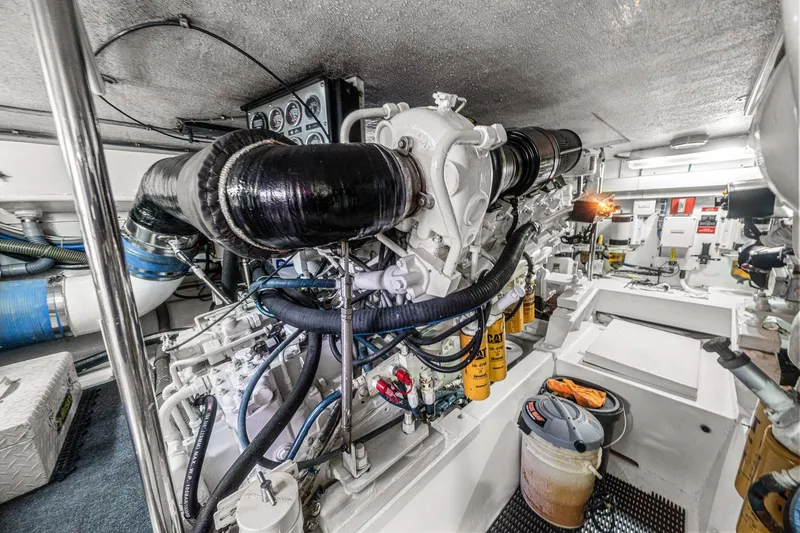 Slide: The Image of Engine room of 2002 Hatteras 60 Convertible yacht, showcasing detailed machinery and components. - 71
