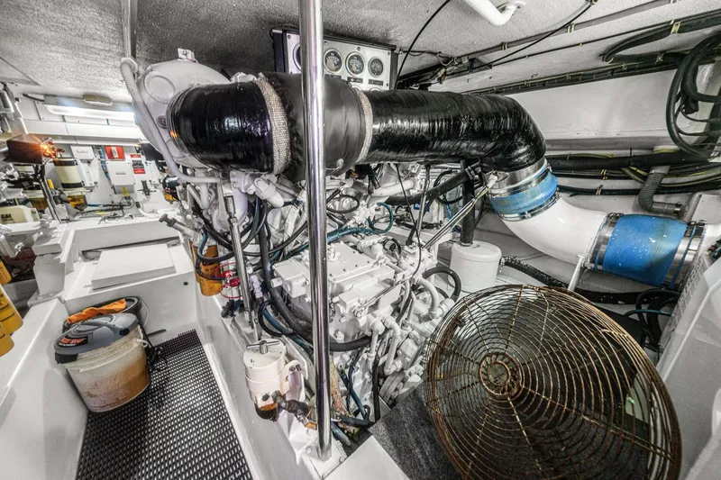 Slide: The Image of Engine room of 2002 Hatteras 60 Convertible yacht, showcasing machinery and equipment. - 72