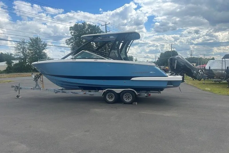 The Image of 2026 Chaparral 280 OSX boat on trailer under cloudy sky. - 1