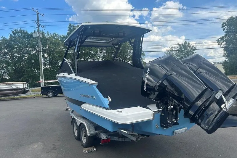 Slide: The Image of 2026 Chaparral 280 OSX boat with dual Mercury engines on a trailer. - 10