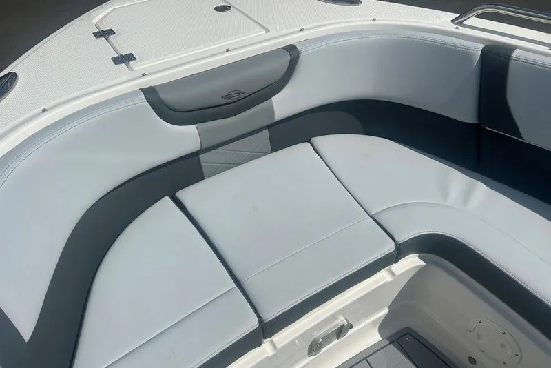 Slide: The Image of 2026 Chaparral 280 OSX boat interior with cushioned seating area. - 16