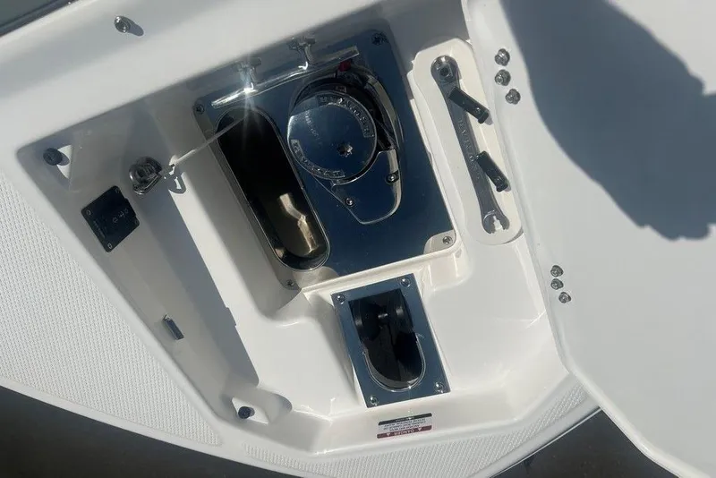 Slide: The Image of 2026 Chaparral 280 OSX boat compartment with mechanical components and tools. - 21