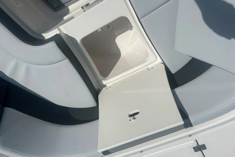 Slide: The Image of Open storage compartment on 2026 Chaparral 280 OSX boat with cushioned seating. - 23