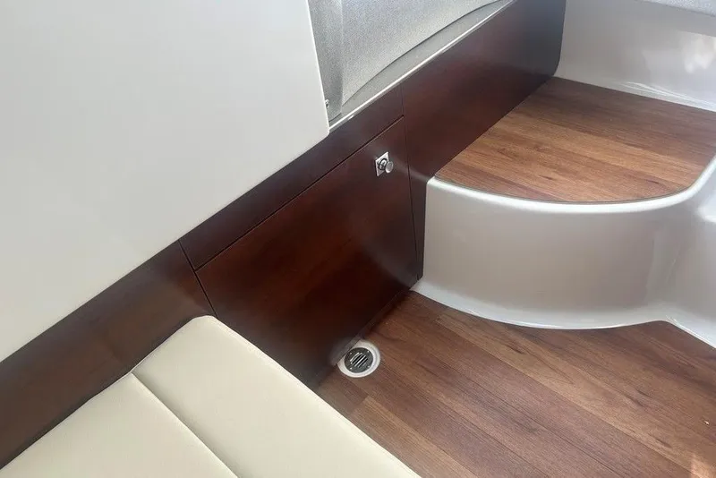 Slide: The Image of Interior of 2026 Chaparral 280 OSX boat with wood flooring and seating. - 29