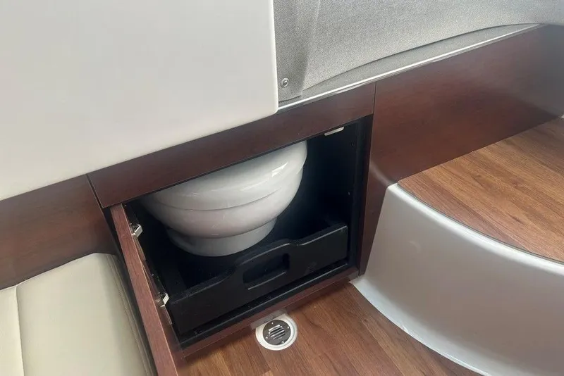 Slide: The Image of 2026 Chaparral 280 OSX boat interior with hidden toilet compartment. - 30
