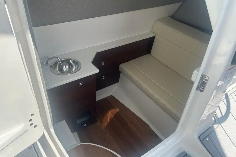 Slide: The Image of 2026 Chaparral 280 OSX cabin interior with sink and seating area. - 31