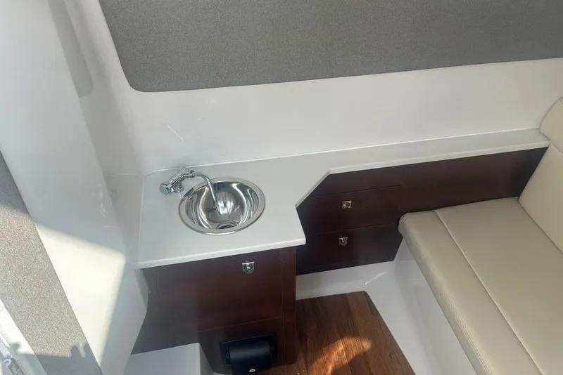 Slide: The Image of Interior of 2026 Chaparral 280 OSX boat with sink and seating area. - 33