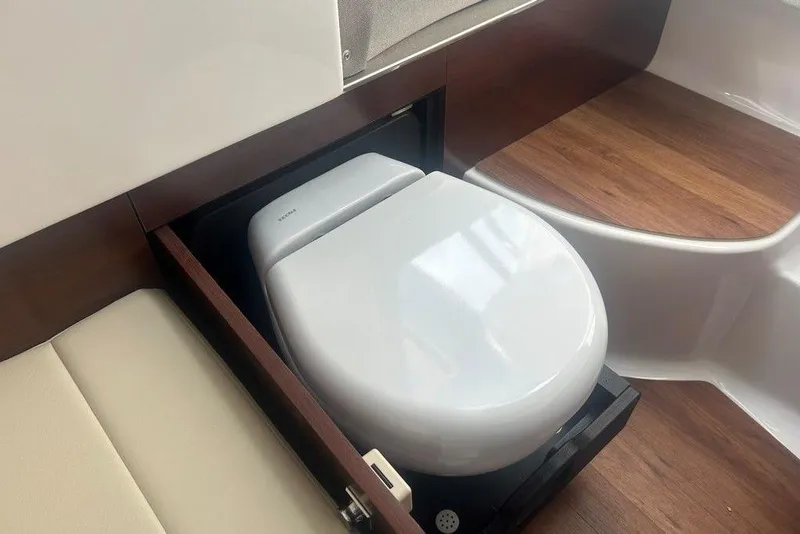 Slide: The Image of 2026 Chaparral 280 OSX boat interior with a modern, compact toilet design. - 34