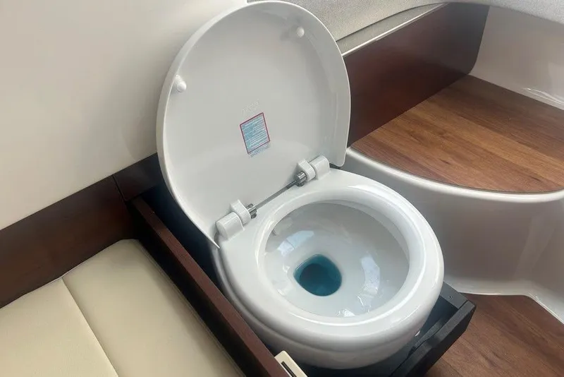Slide: The Image of 2026 Chaparral 280 OSX boat interior with a modern marine toilet. - 36