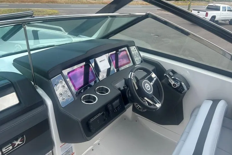Slide: The Image of 2026 Chaparral 280 OSX boat dashboard with modern controls and dual displays. - 46