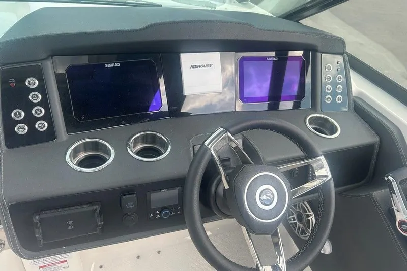 Slide: The Image of Dashboard of 2026 Chaparral 280 OSX boat with steering wheel and digital displays. - 47