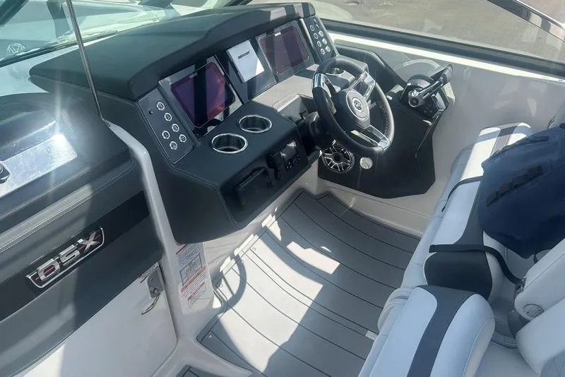 Slide: The Image of 2026 Chaparral 280 OSX boat cockpit with modern steering and digital displays. - 48