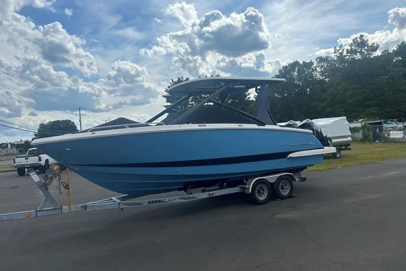 Slide: The Image of 2026 Chaparral 280 OSX boat on trailer under cloudy sky. - 5