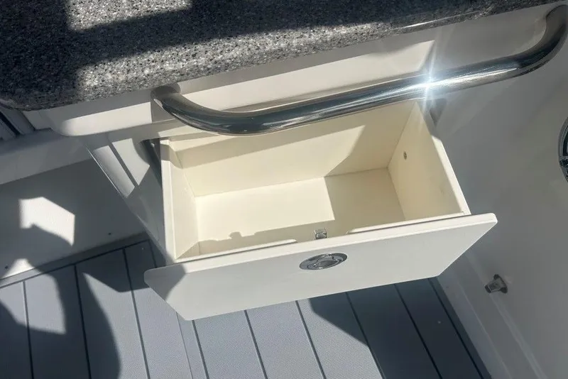 Slide: The Image of Open drawer on Chaparral 280 OSX 2026 boat with granite countertop. - 55