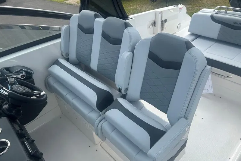 Slide: The Image of 2026 Chaparral 280 OSX boat interior with modern seating and steering wheel. - 57