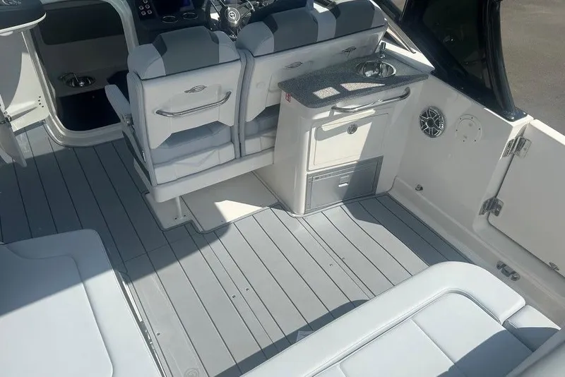 Slide: The Image of 2026 Chaparral 280 OSX boat interior with seating, sink, and modern design. - 61