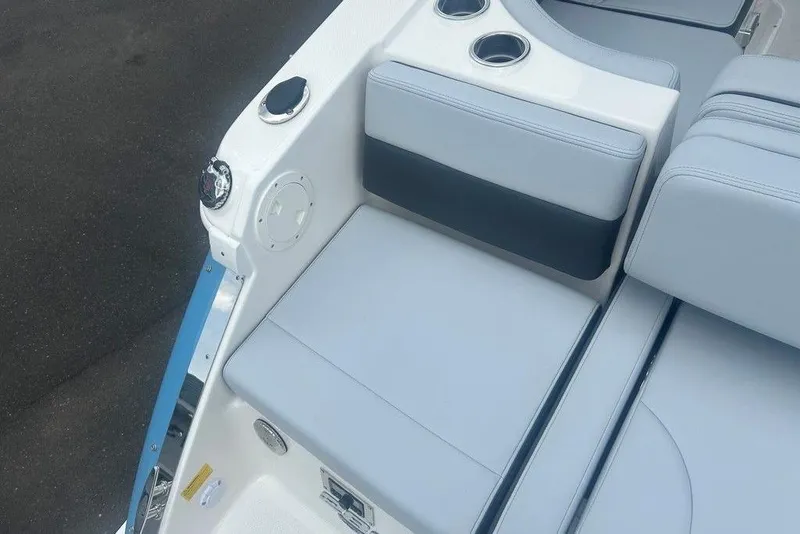 Slide: The Image of 2026 Chaparral 280 OSX boat interior with cushioned seating and cup holders. - 64