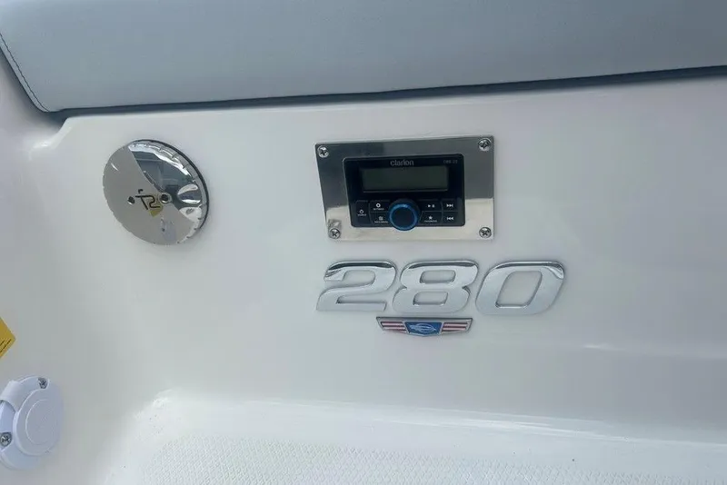 Slide: The Image of 2026 Chaparral 280 OSX boat dashboard with control panel and emblem. - 67