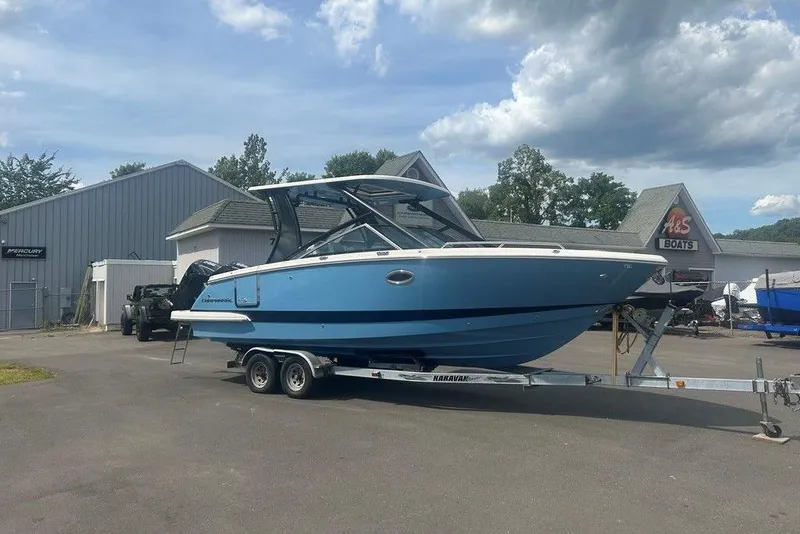 Slide: The Image of 2026 Chaparral 280 OSX boat on trailer at dealership under cloudy sky. - 7