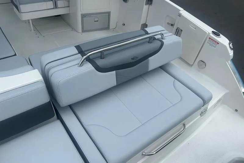 Slide: The Image of 2026 Chaparral 280 OSX boat interior with sleek, modern seating and stainless steel accents. - 73