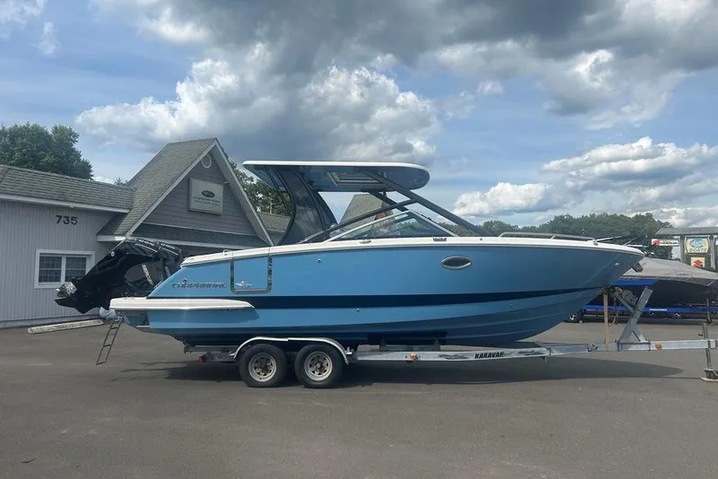 Slide: The Image of 2026 Chaparral 280 OSX boat on trailer, parked outdoors under cloudy sky. - 8
