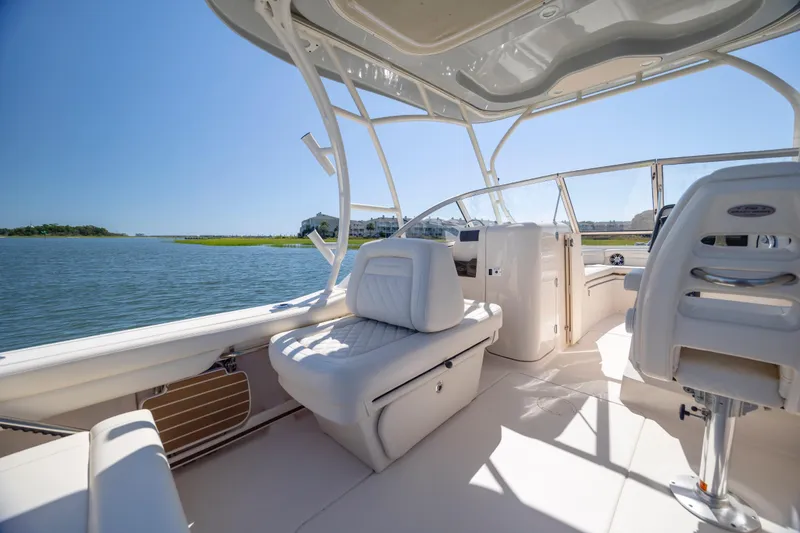Slide: The Image of 2023 Grady-White Freedom 235 boat interior with seating, on a sunny day by the water. - 13