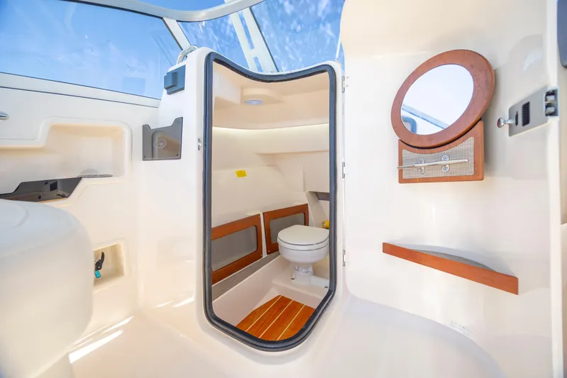 Slide: The Image of 2023 Grady-White Freedom 235 boat interior with toilet and mirror. - 23