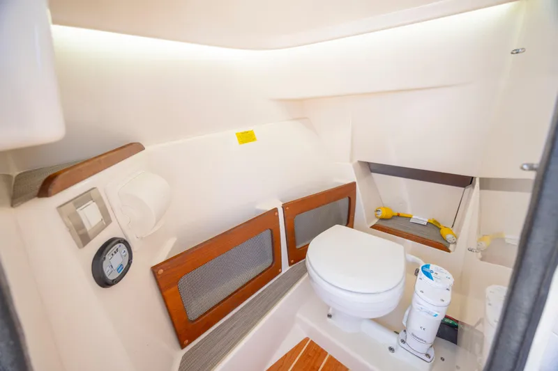Slide: The Image of 2023 Grady-White Freedom 235 boat interior with modern marine toilet and storage. - 24