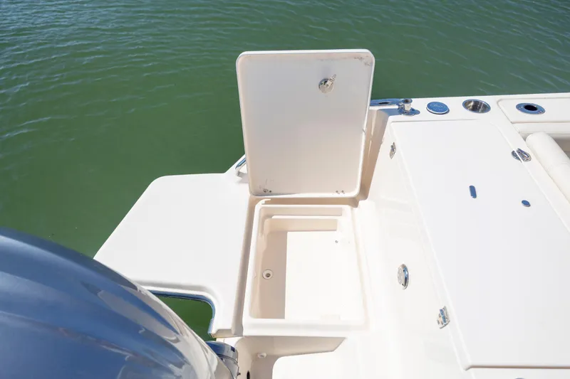 Slide: The Image of 2023 Grady-White Freedom 235 boat with open storage compartment on deck. - 28