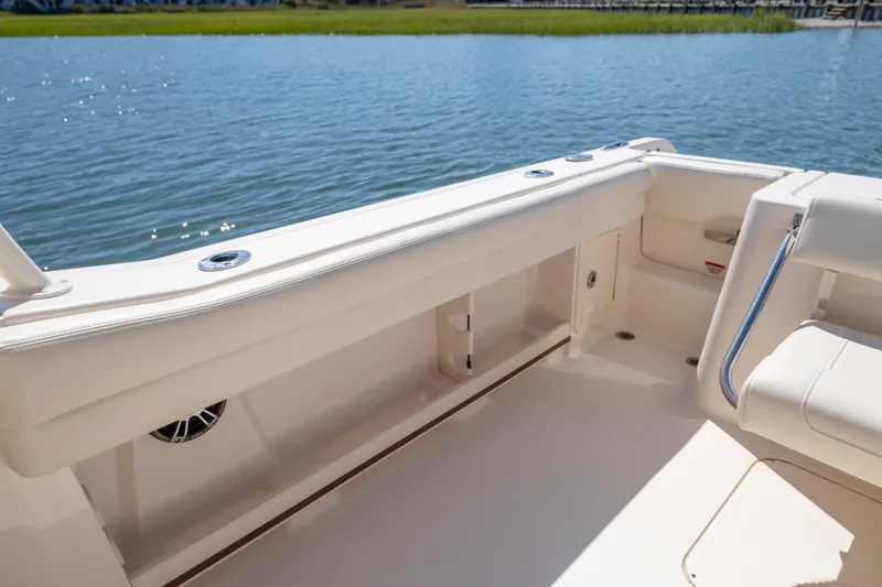 Slide: The Image of 2023 Grady-White Freedom 235 boat interior with seating, overlooking calm water. - 29