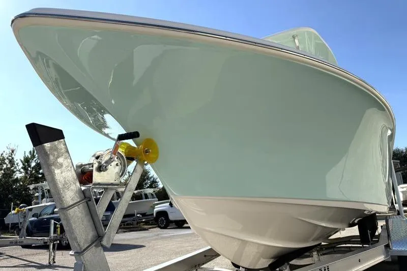 Slide: The Image of 2025 Key West 239 FS boat on trailer under clear blue sky. - 10