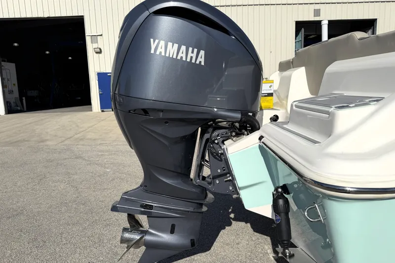 Slide: The Image of 2025 Key West 239 FS boat with Yamaha outboard motor in a marina setting. - 12