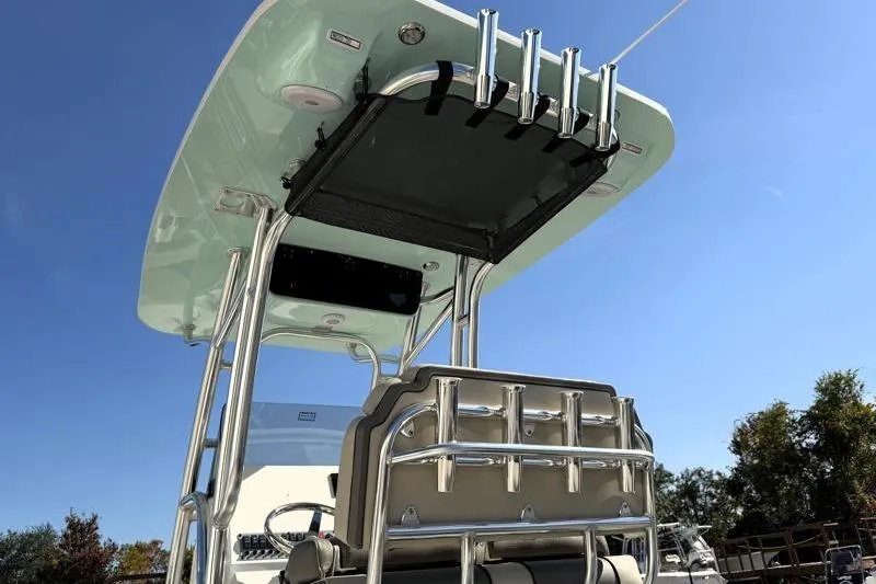 Slide: The Image of 2025 Key West 239 FS boat with T-top and rod holders under clear blue sky. - 18