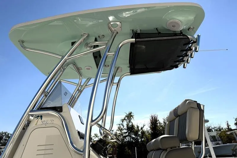 Slide: The Image of 2025 Key West 239 FS boat with sleek T-top and seating, under clear blue sky. - 19