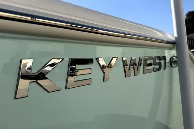 Slide: The Image of Key West 239 FS 2025 boat logo in shiny chrome finish. - 20
