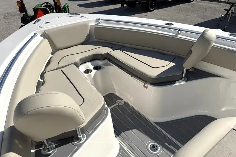 Slide: The Image of 2025 Key West 239 FS boat interior with beige seating and cup holders. - 22