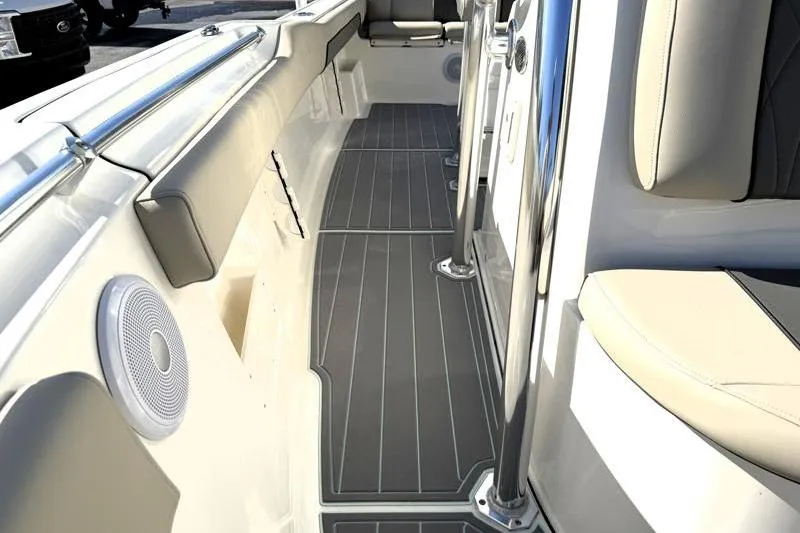 Slide: The Image of 2025 Key West 239 FS boat interior with cushioned seating and sleek flooring. - 30