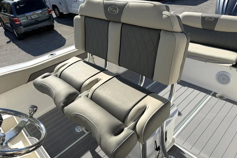 Slide: The Image of 2025 Key West 239 FS boat interior with cushioned seating and steering wheel. - 33