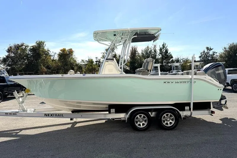 Slide: The Image of 2025 Key West 239 FS boat on trailer, side view, outdoors. - 4