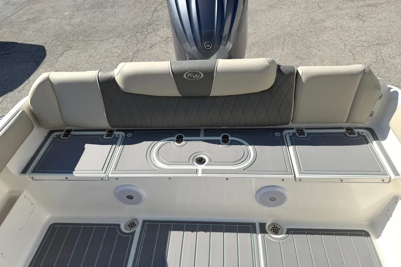 Slide: The Image of 2025 Key West 239 FS boat interior with cushioned seating and storage compartments. - 43