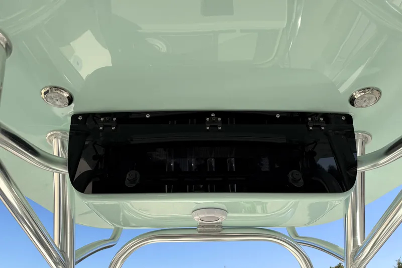 Slide: The Image of 2025 Key West 239 FS boat T-top underside with mounted equipment and stainless steel supports. - 48