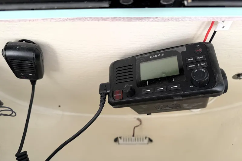 Slide: The Image of Garmin marine radio and microphone on 2025 Key West 239 FS boat dashboard. - 49