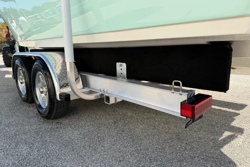 Slide: The Image of 2025 Key West 239 FS boat trailer with dual wheels and red reflector. - 56