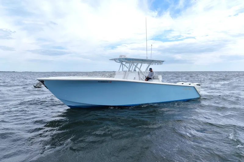 Slide: The Image of 2019 SeaHunter 33 Tournament boat on open water under cloudy sky. - 0