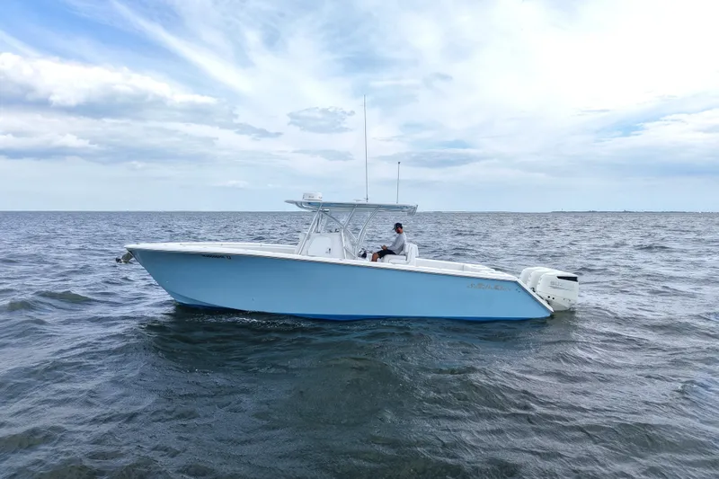 Slide: The Image of 2019 SeaHunter 33 Tournament boat on open water under a cloudy sky. - 1