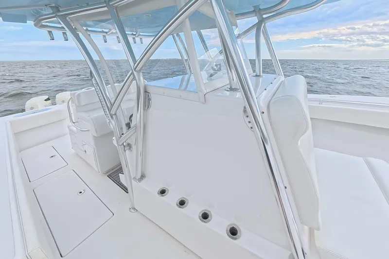 Slide: The Image of 2019 SeaHunter 33 Tournament boat interior with sleek white seating and ocean backdrop. - 14