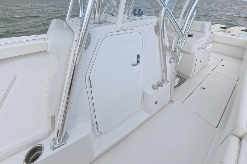 Slide: The Image of 2019 SeaHunter 33 Tournament boat interior with sleek white seating and storage compartments. - 15