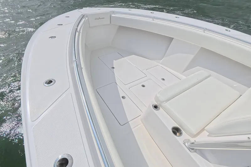 Slide: The Image of 2019 SeaHunter 33 Tournament boat deck with white seating and storage compartments. - 17