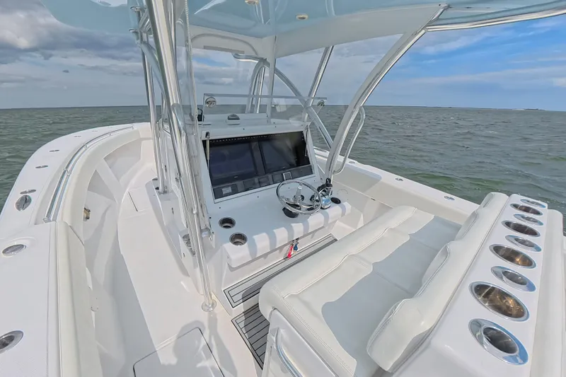 Slide: The Image of 2019 SeaHunter 33 Tournament boat interior with helm, ocean view, and clear sky. - 21