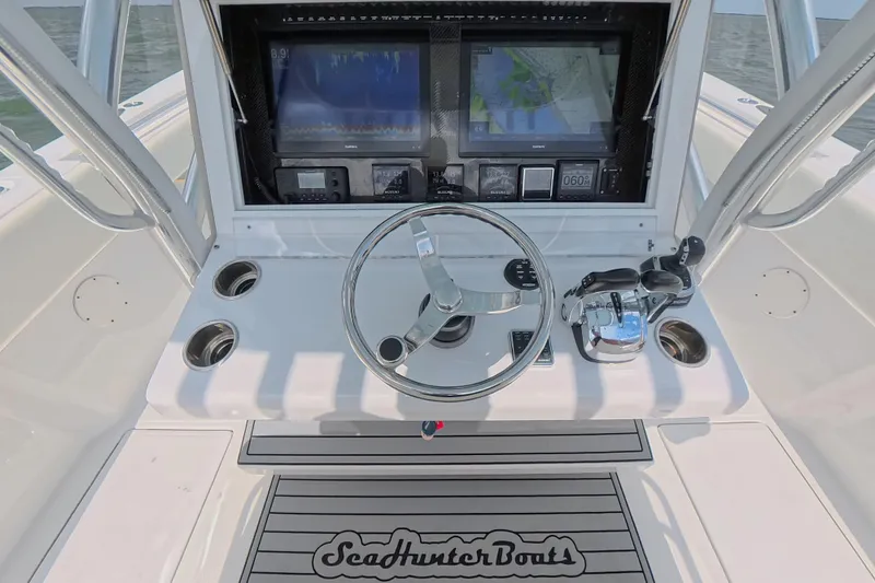 Slide: The Image of 2019 SeaHunter 33 Tournament boat helm with steering wheel and navigation screens. - 23